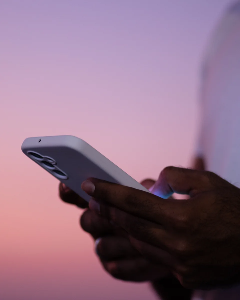 Clinician reviewing healthcare information on a phone at sunset